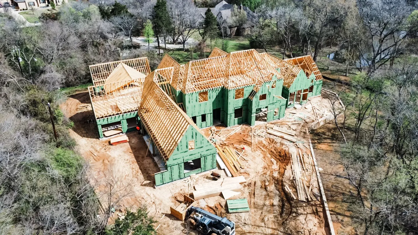 Aerial view of a Slate Stone Construction home under framing in Texas