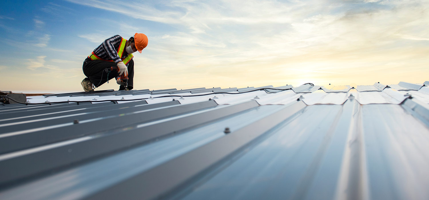 roofing contractor working on metal roof